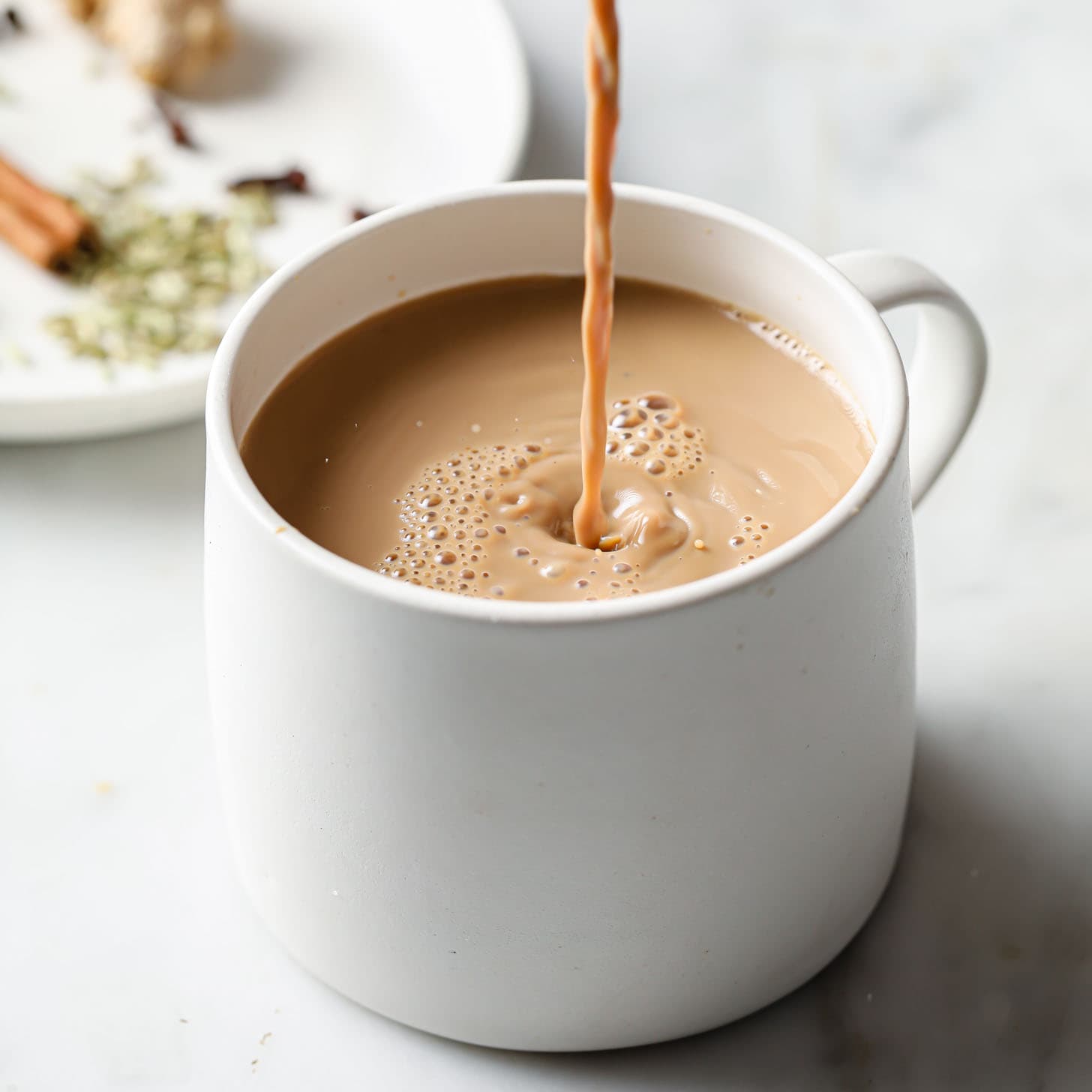 Traditional Doodh Patti pouring into mug